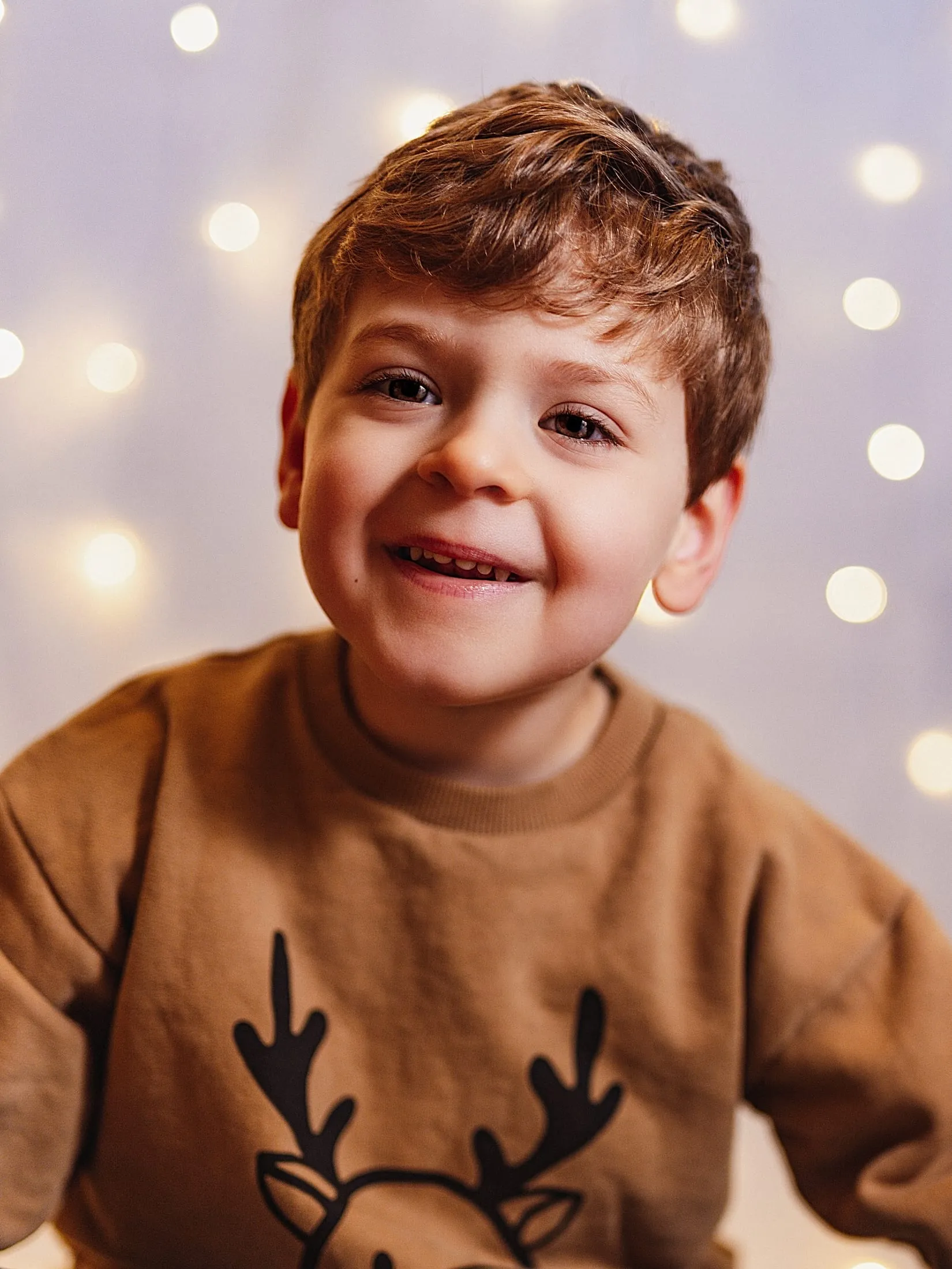 Smiling young boy in a knitted jumper