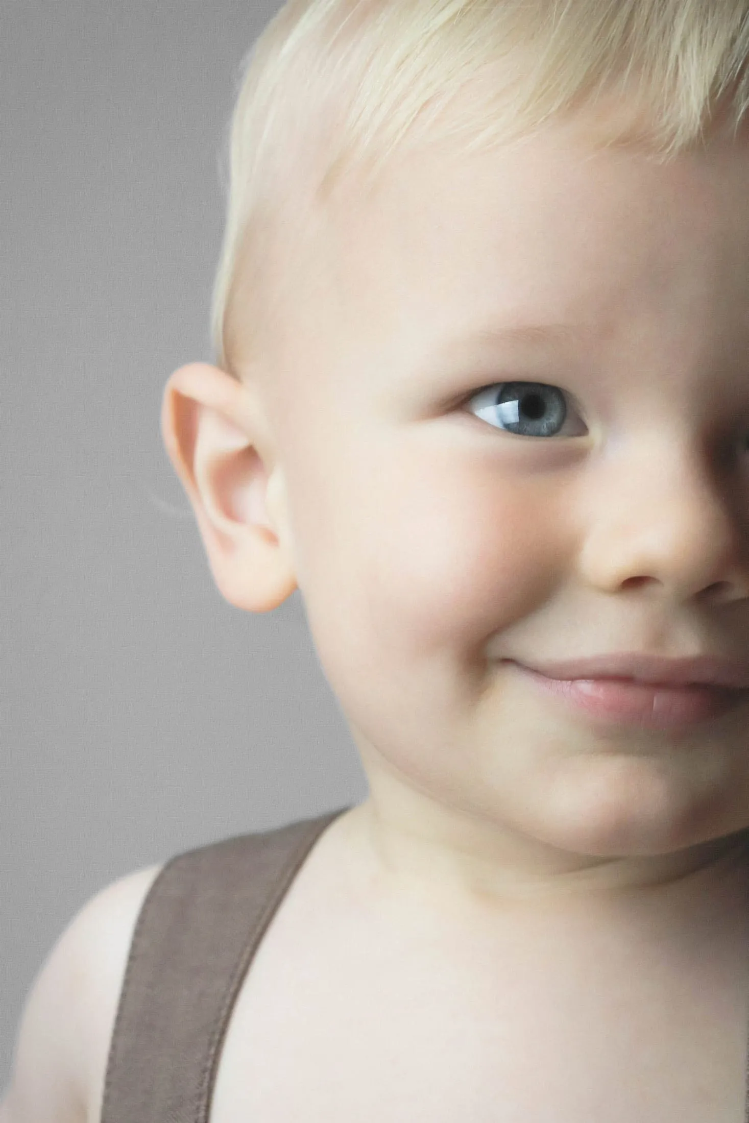 Smiling young boy, close-up studio portrait